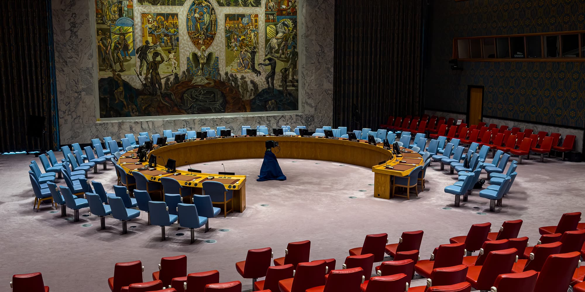 The United Nations Security Council chamber in New York, horseshoe table and mural